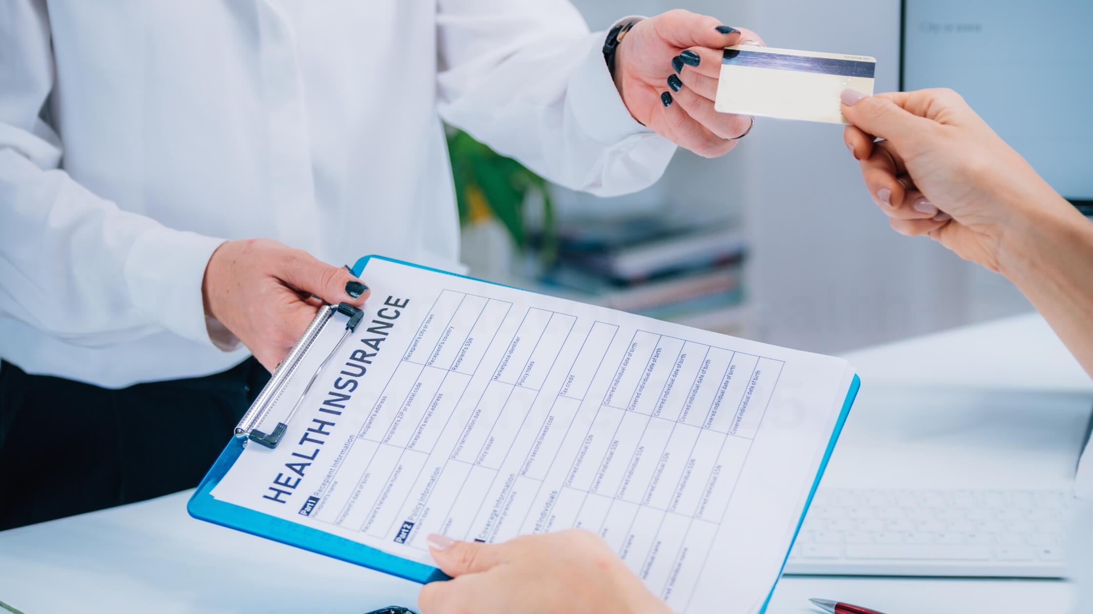 UAE healthcare workers reviewing medical insurance documents with Ministry of Human Resources and Emiratisation